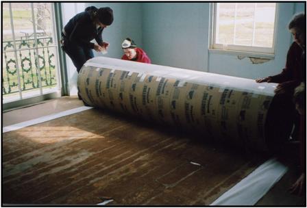 Carefully rolling floorcloth for transport